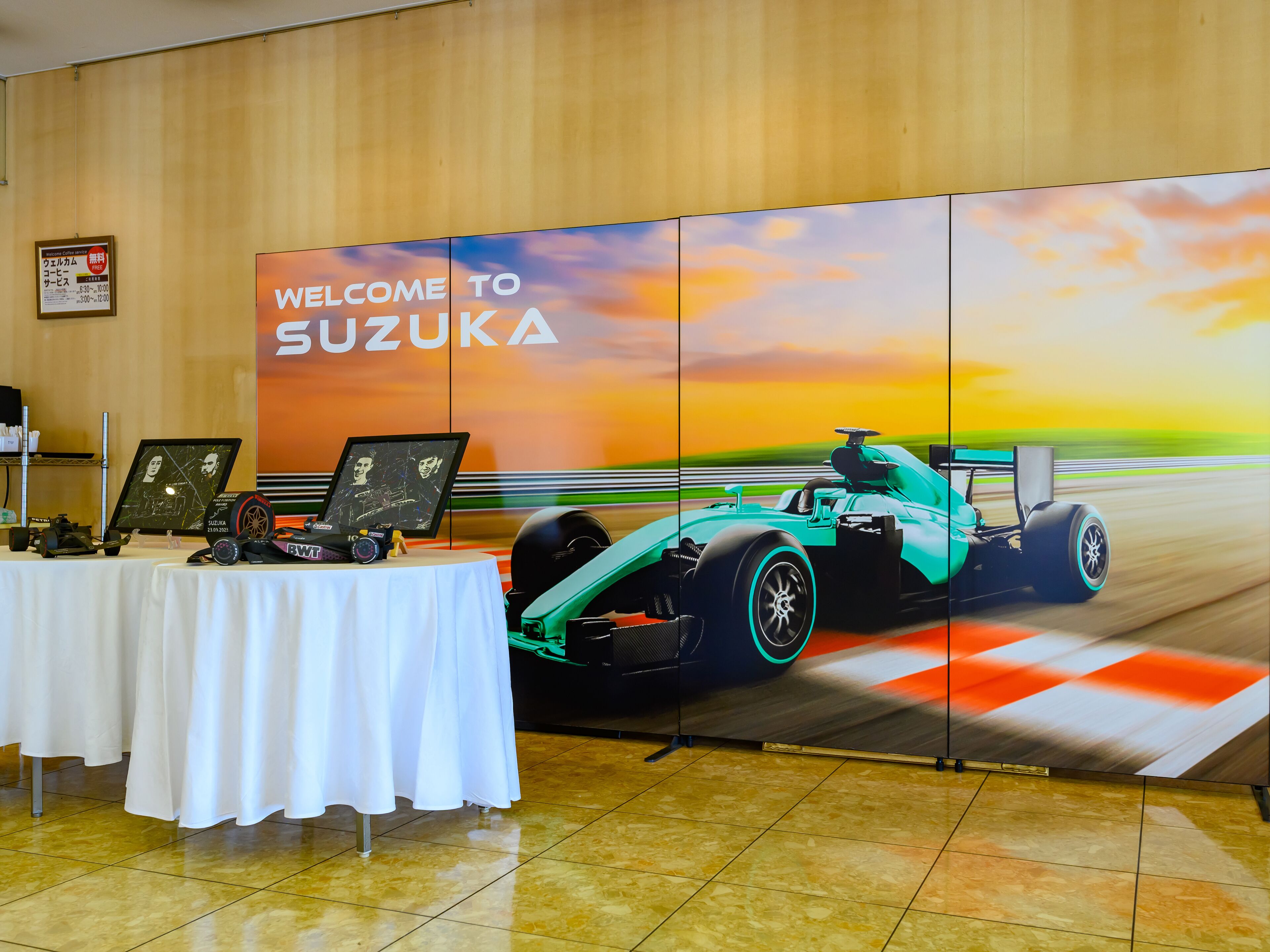A display with a racing car and a 'Welcome to SUZUKA' sign.