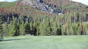 A golf course with a mountain backdrop. - Five Star Grand Lodge @ Peak 7:  Week of July 4th! (Breckenridge)