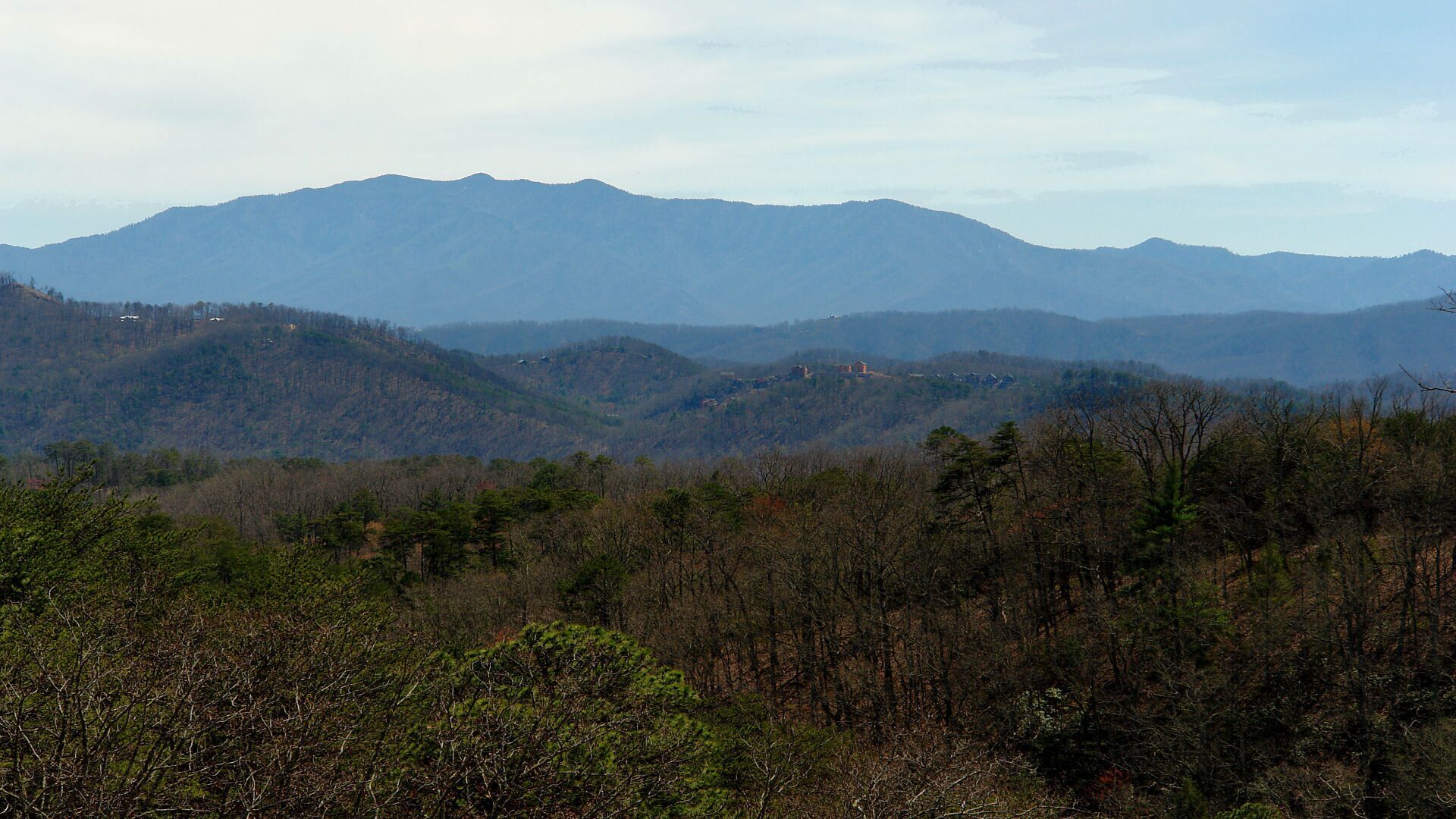 A mountainous landscape with scattered buildings.
