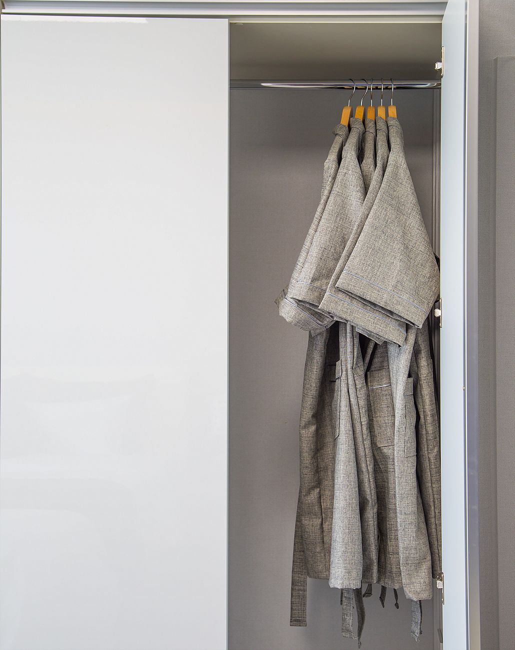 A closet with hanging clothes on a rod.