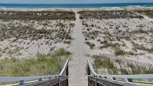 A beach pathway leading to the ocean with wooden railings on both sides. - Oceans 111 | Oceanfront with Elevator + Direct Beach Access! (Topsail Beach)