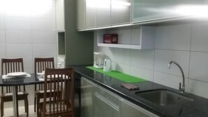 A kitchen with a dining table, chairs, a coffee maker, and a sink. - Mama Mia Home - Bukit Mertajam (Bukit Mertajam)