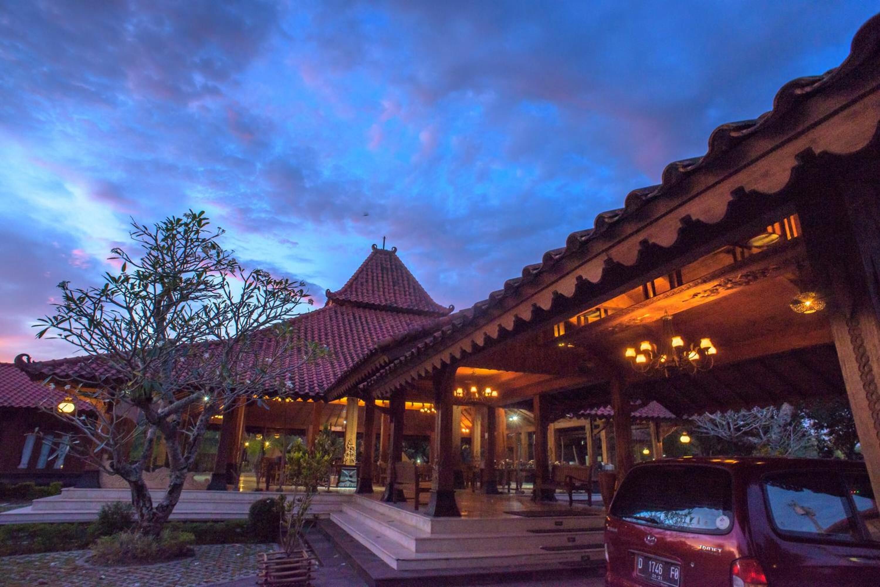 A traditional building with a tiled roof and a covered porch area.