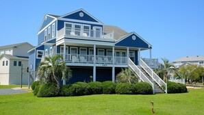 A two-story house with a balcony, a staircase, and a well-maintained lawn. - Long Grass 5 Bedroom Home by RedAwning (Supply)