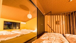 A hotel room with two beds, a large mirror, wooden slats on the wall, and a window with a view of the outside. - IMADEGAWA Kyoto (Kyoto)