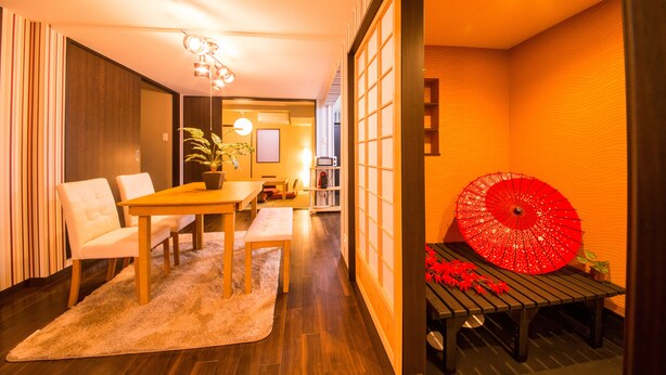 A modern interior with a dining area, a red umbrella, and traditional Japanese sliding doors. - IMADEGAWA Kyoto (Kyoto)