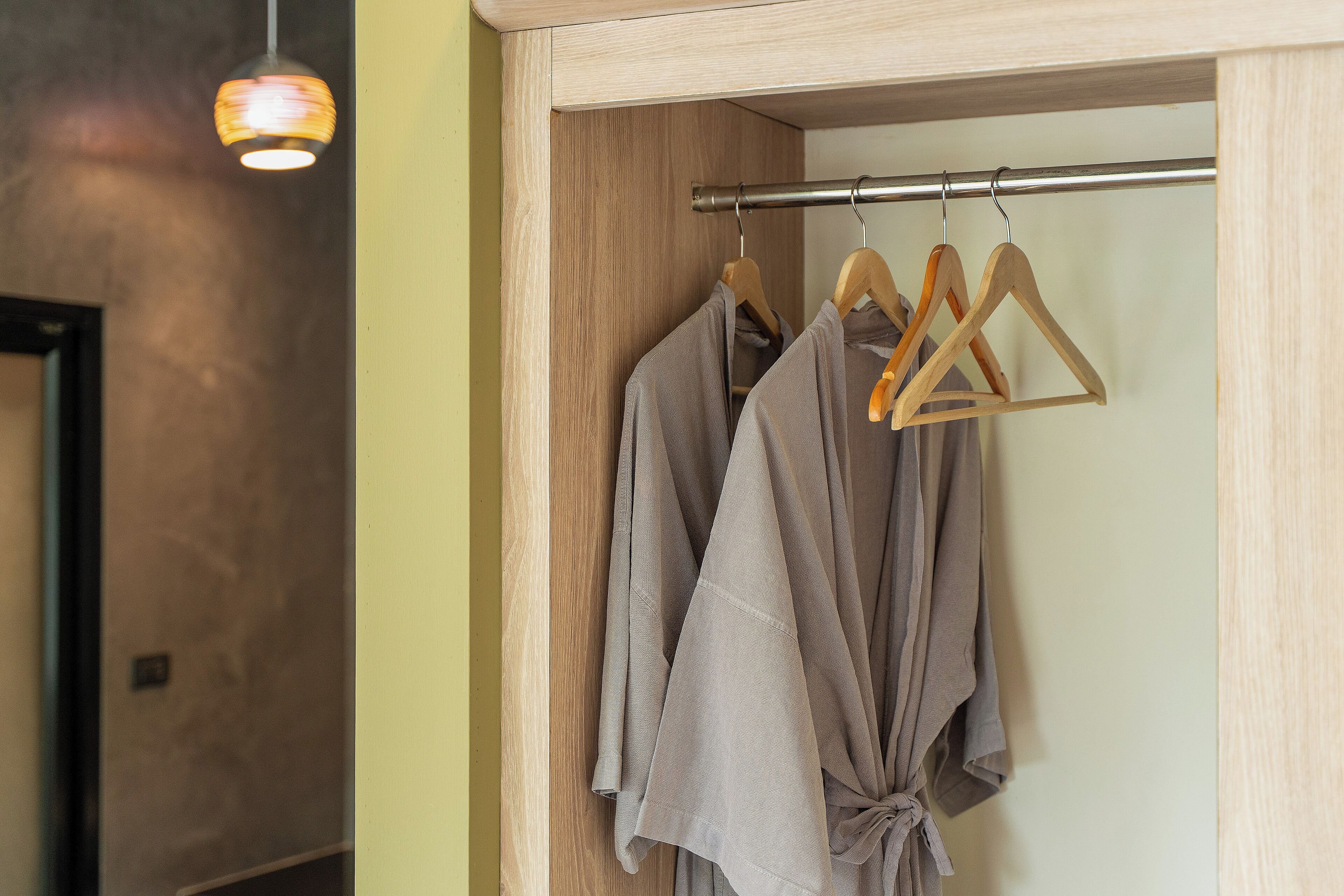 A closet with wooden hangers and a metal rod.