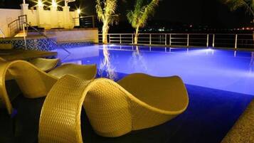 Outdoor pool, open 8 AM to 10 PM, pool loungers