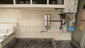 A tiled hot tub with a control panel and a water filtration system. - Wabi Sabi Kyoto (Kyoto)