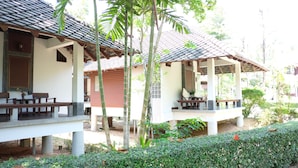 A bungalow-style building with a tiled roof and a covered porch.