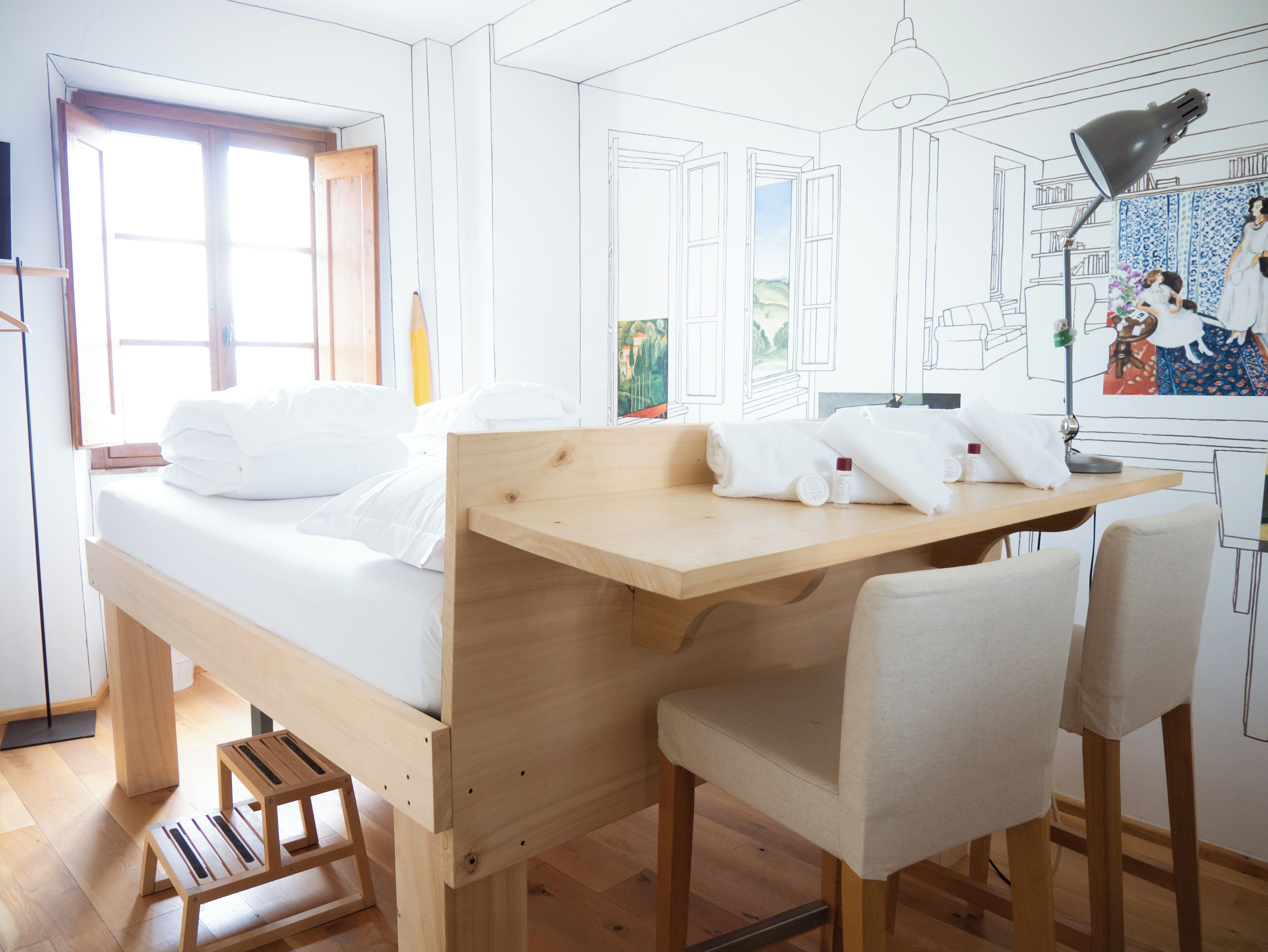 A room with a bed, a desk, and a chair.