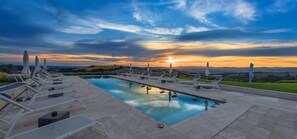 Seasonal outdoor pool, a rooftop pool, pool umbrellas, pool loungers