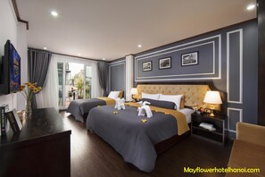 A hotel room with two beds, a TV, a desk, and a balcony with curtains. - Mayflower Hotel Hanoi (Hanoi)