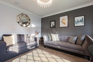 Premium Apartment, 2 Bedrooms, Ground Floor | Living area | 49-inch flat-screen TV with satellite channels, TV, books