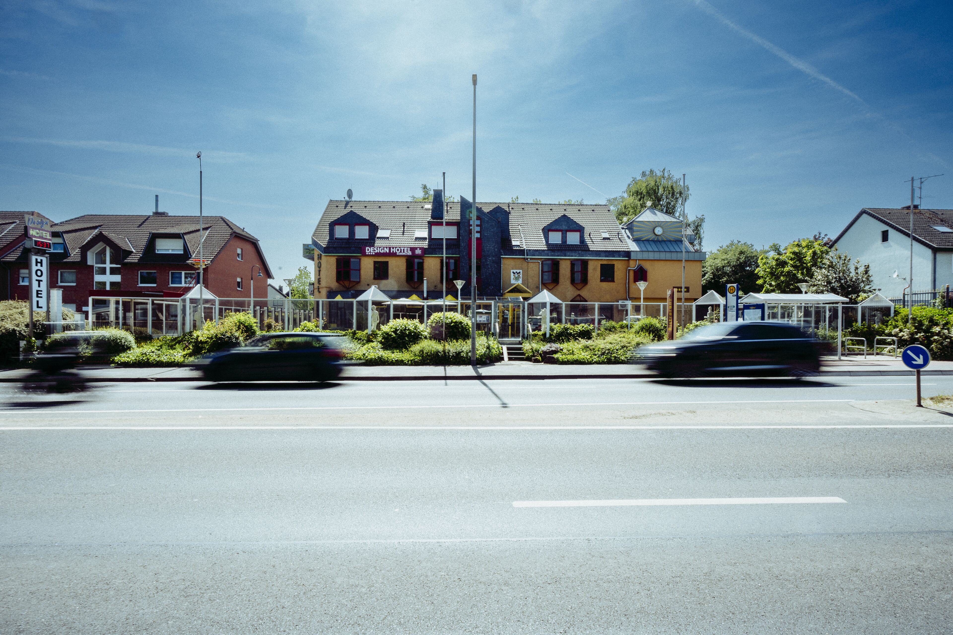 A hotel with a distinct architectural style, featuring a prominent sign and a well-maintained facade.