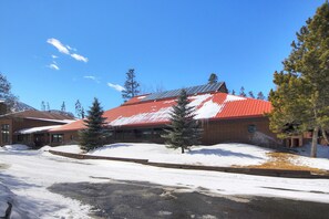 A building with a red roof and snow-covered surroundings.