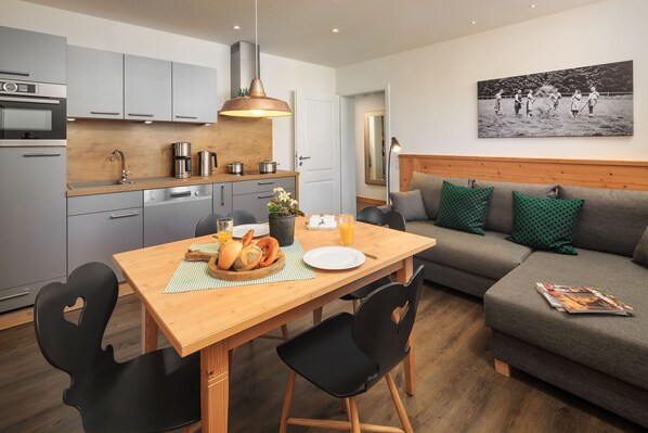 Enjoy a comfortable stay in this well-appointed living space with a fully equipped kitchen, dining area, and cozy seating area.