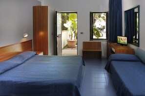 Habitación triple | Escritorio, espacio para trabajar con laptop y cortinas blackout 