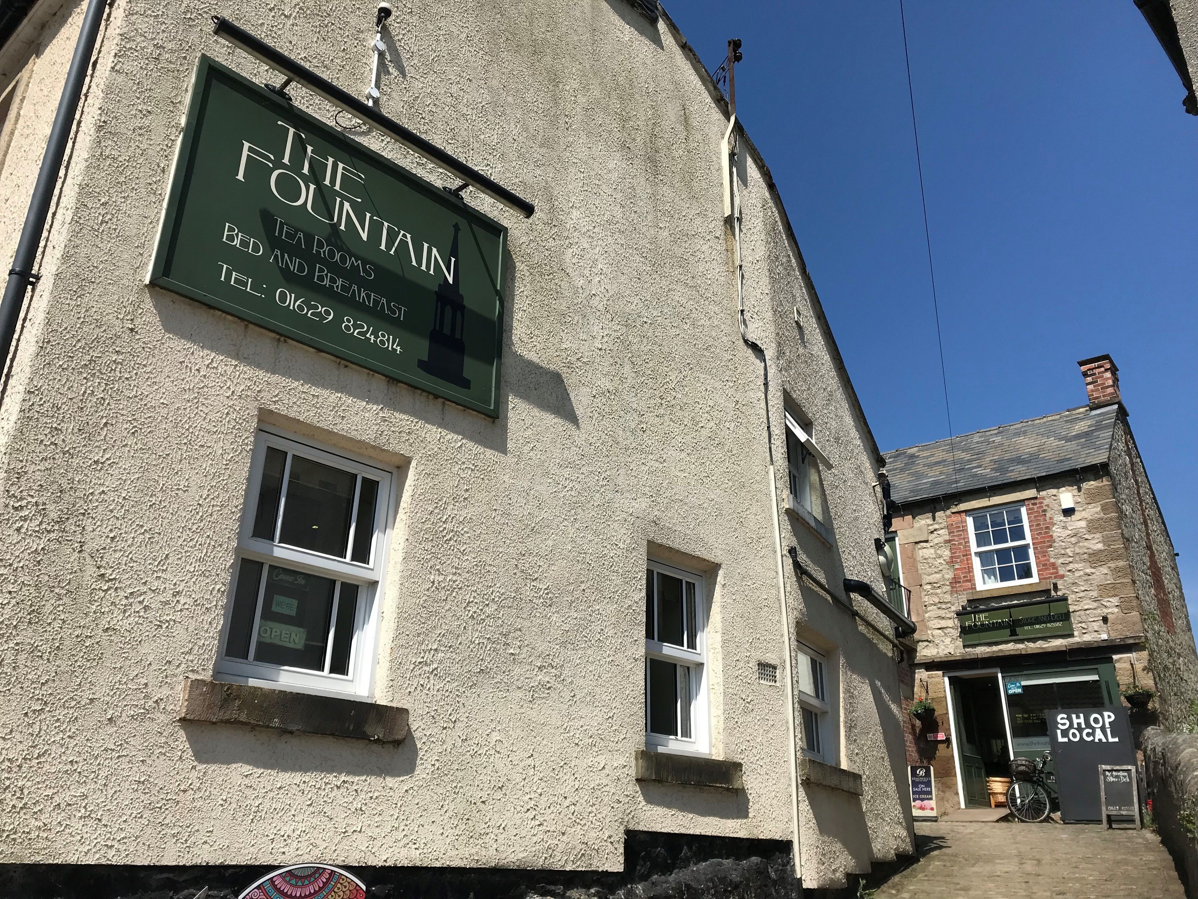 The Fountain building with a sign advertising bed and breakfast services.