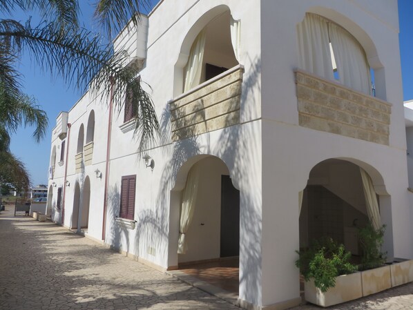 A building with multiple arches and a tiled courtyard.