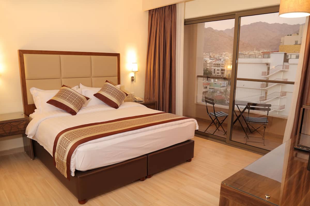 deluxe room, 1 bedroom, refrigerator, partial sea view | in-room safe, desk, soundproofing, iron/ironing board