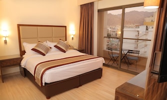Deluxe Room, 1 Bedroom, Refrigerator, Partial Sea View | In-room safe, desk, soundproofing, iron/ironing board