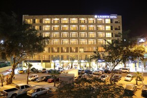 A multi-story hotel with a uniform facade, multiple windows, and a sign indicating it is the Lacosta Hotel. - Lacosta Hotel (Aqaba)