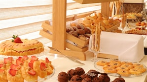 A buffet with various baked goods, including pastries, bread, and desserts. - Lacosta Hotel (Aqaba)