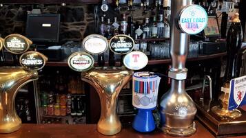 Un bar con varias cañas, incluyendo marcas como Guinness y Peroni.