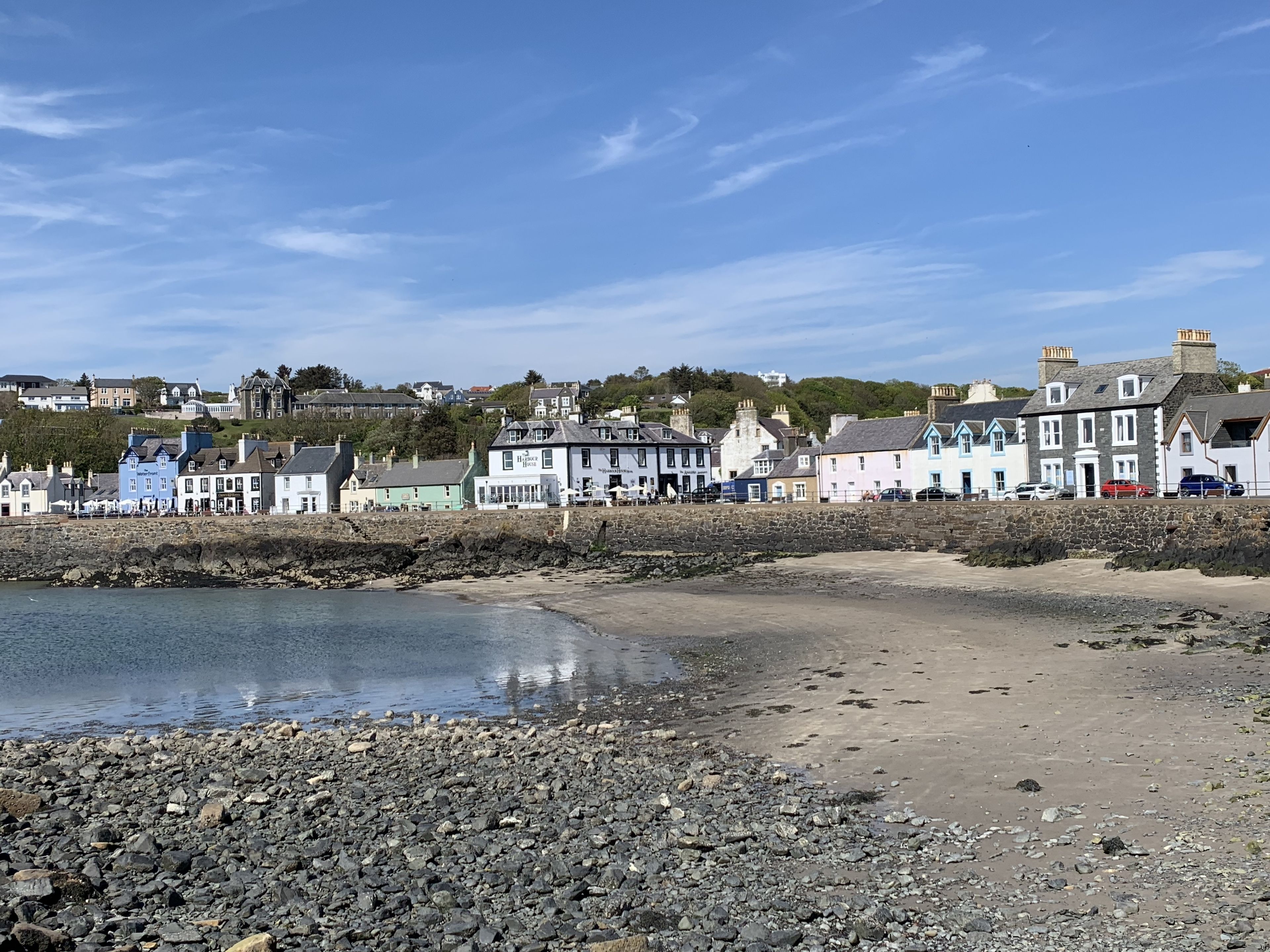 A coastal town with stone buildings along the beach.