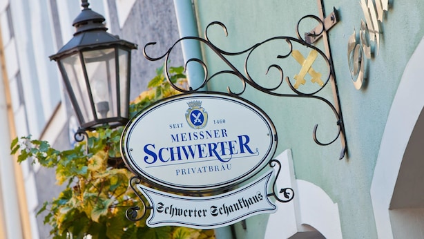 A sign for a private brewery named "Meissner Schwächter" with a decorative metal frame and a crown emblem.