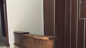 A wooden reception desk with a built-in bench, located at the top of a staircase. - Deeps Hostel (Eskisehir)