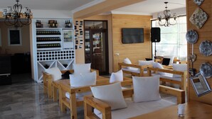 A modern interior with wooden furniture, a wine rack, and a TV mounted on the wall.