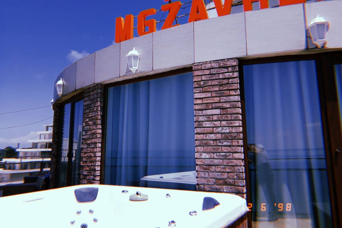 A hotel exterior with a sign reading "HOTEL MGZAVREB".