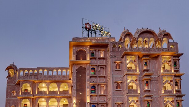 A multi-story building with intricate architectural details, including arched windows and balconies, and a sign indicating it is a hotel. - Radhey Ki Haveli (Danta Ramgarh)