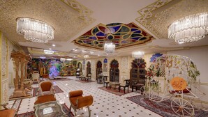 A luxurious interior with chandeliers, ornate furniture, and a patterned floor. - Radhey Ki Haveli (Danta Ramgarh)