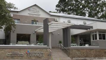A modern building with a sign reading "Hosteria Atahualpa Upanqui" and "TAFI VIEJO TUCUMAN".