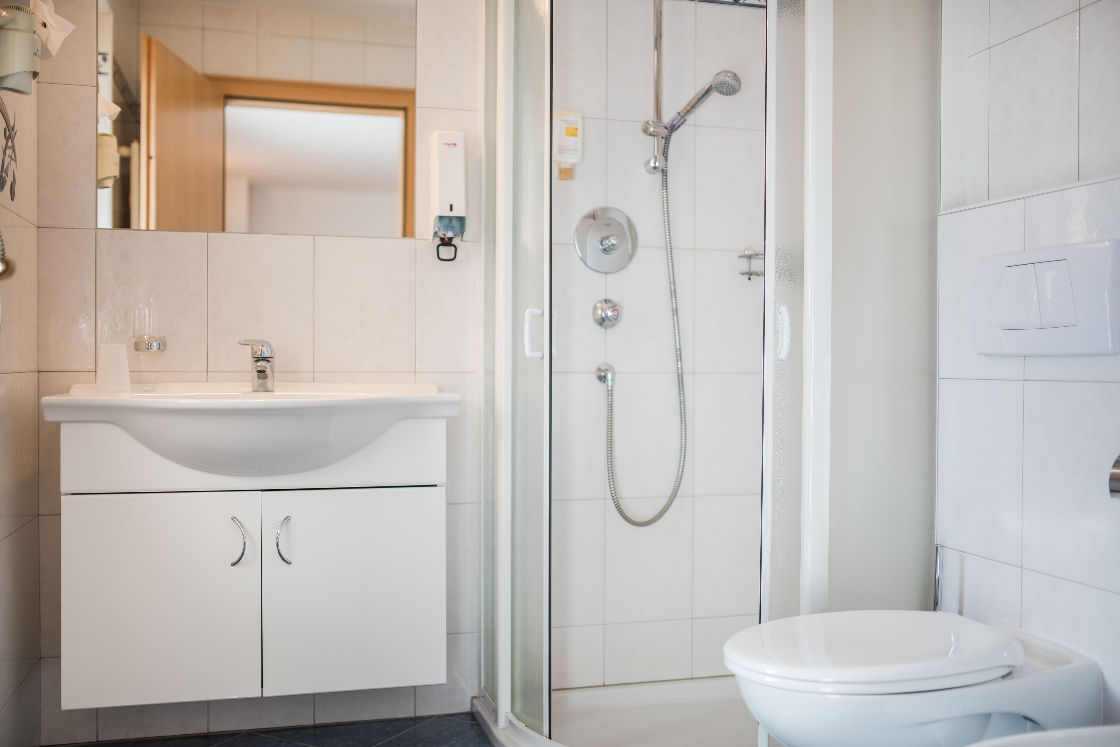 standard double room | bathroom | shower, rainfall showerhead, hair dryer, towels