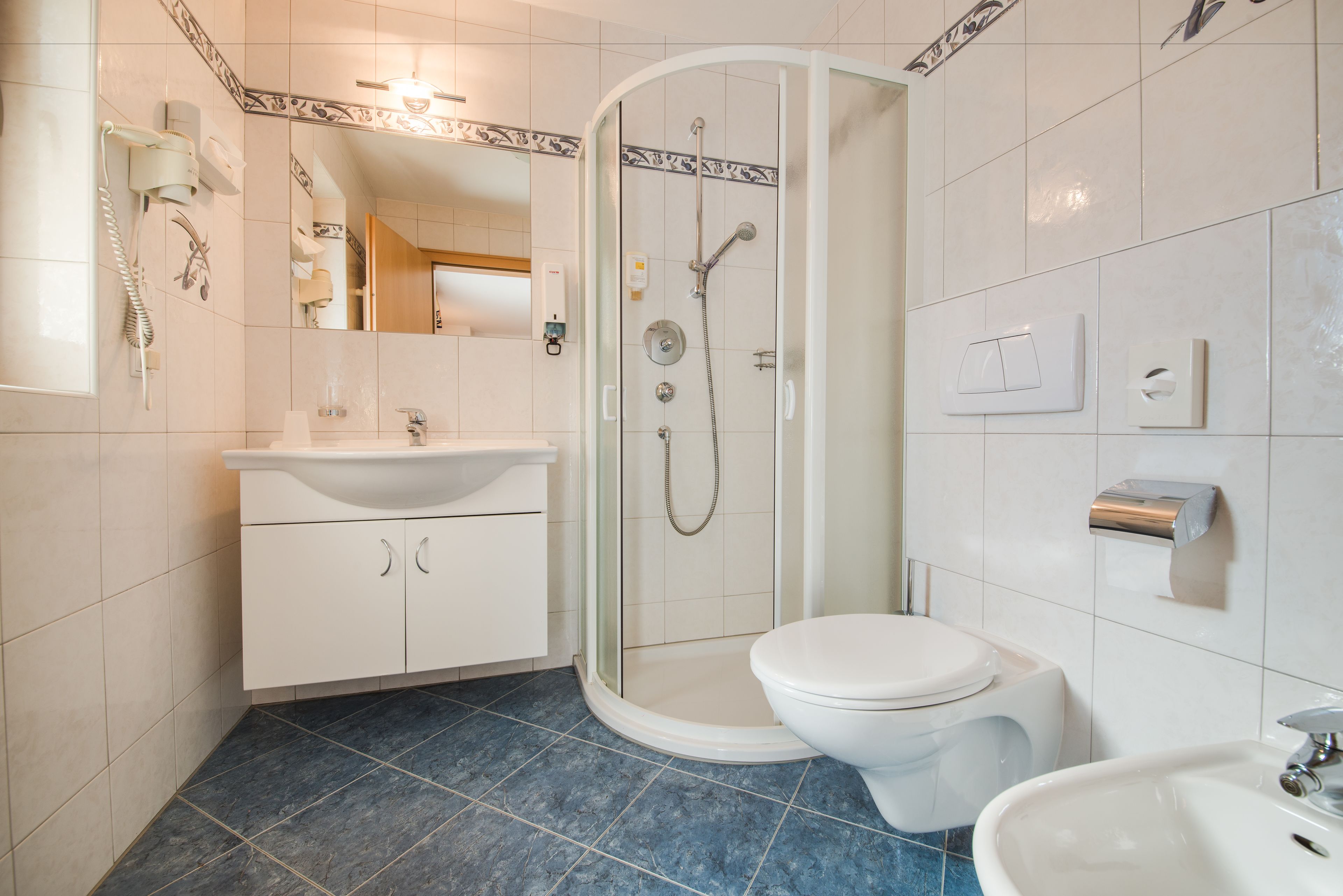 shower, rainfall showerhead, hair dryer, towels