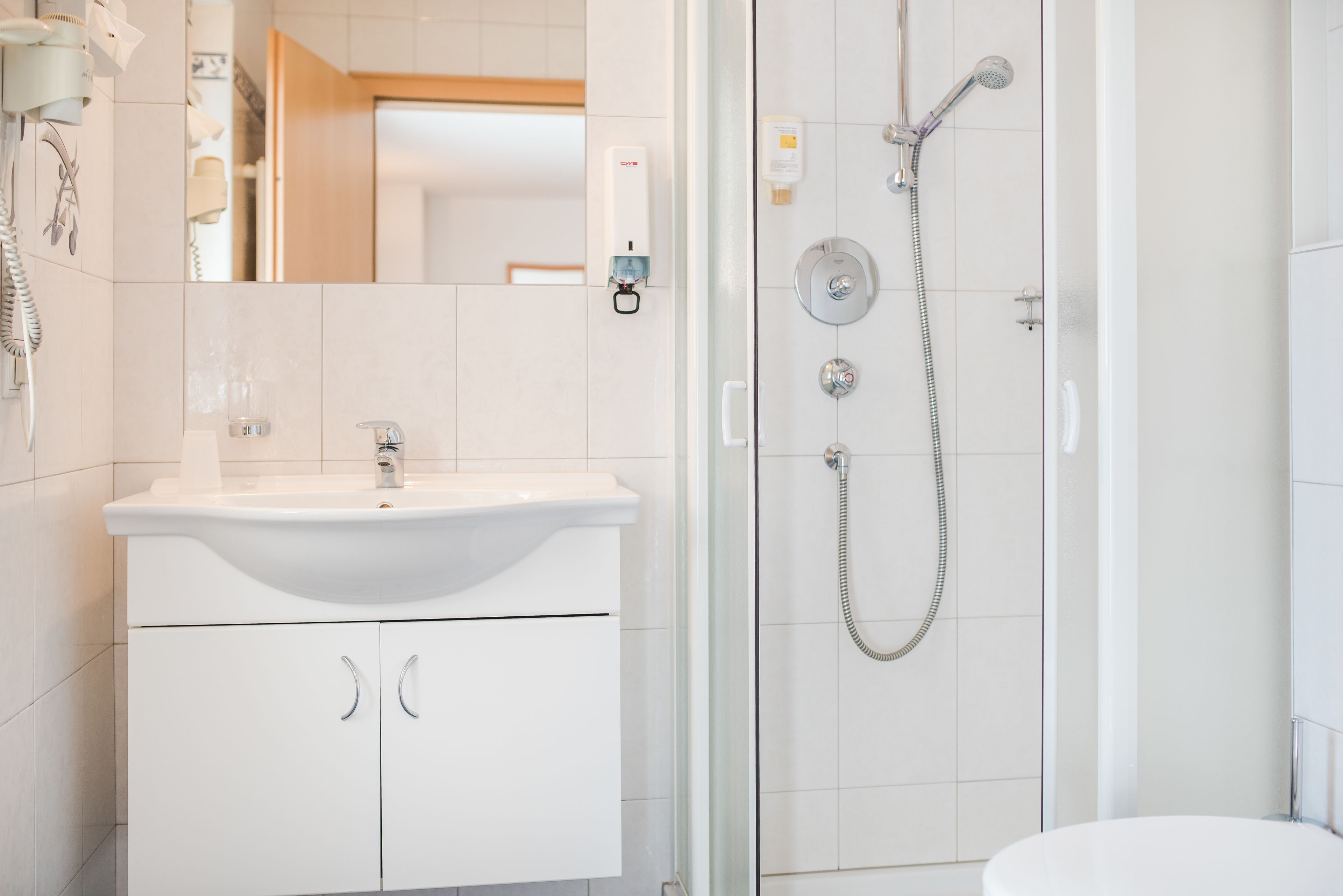 shower, rainfall showerhead, hair dryer, towels