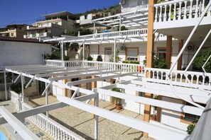 A multi-story residential building with balconies and terraces. - Qeparo Napolon Complex (Himarë)