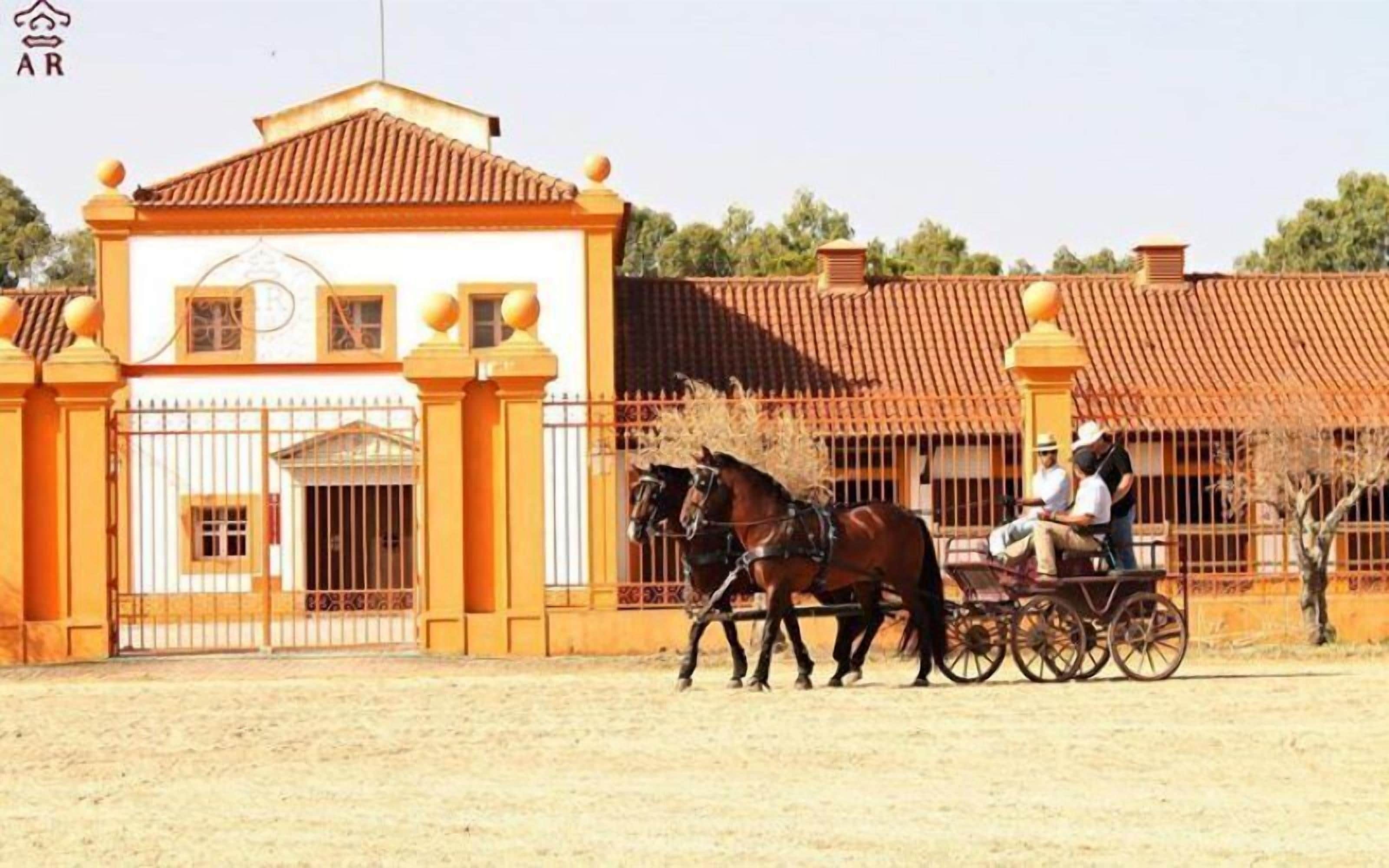 A building with a traditional architectural style, featuring a tiled roof and a gated entrance.