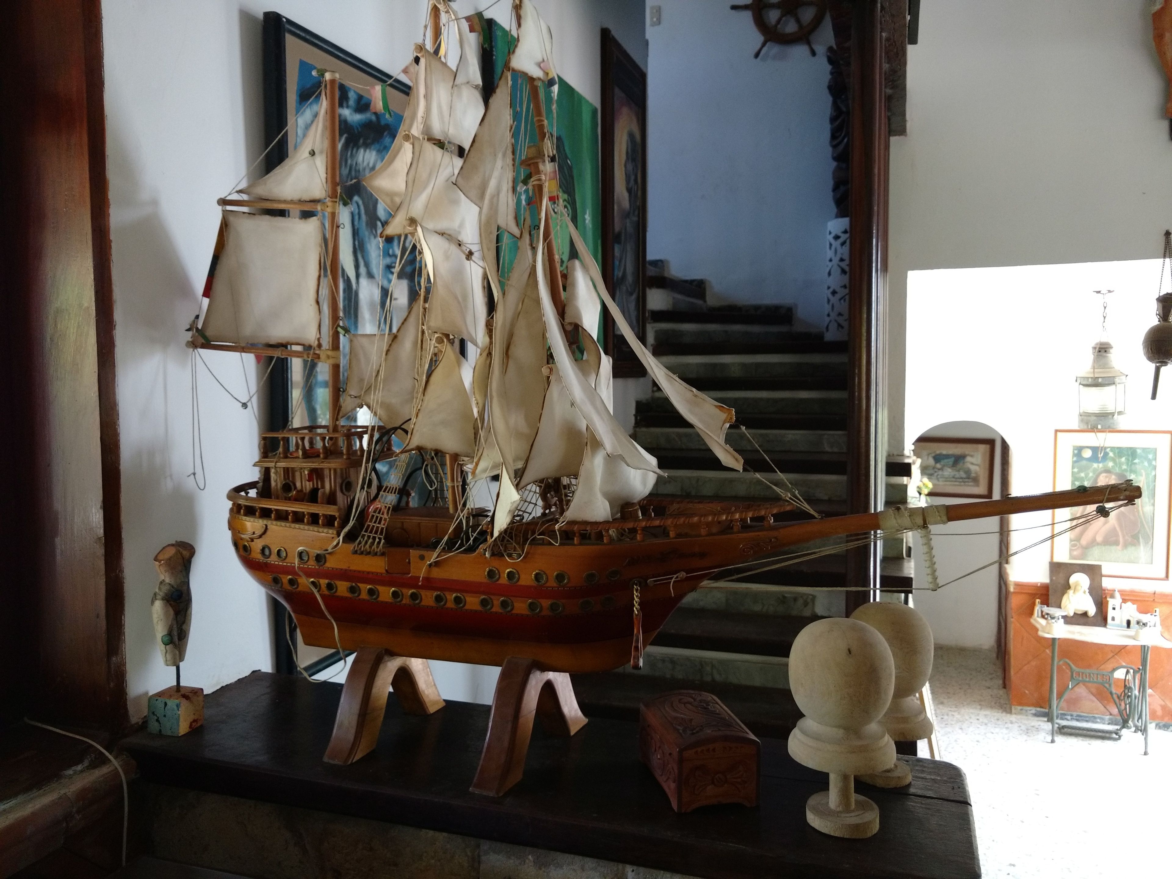 A model ship on display with a staircase in the background.