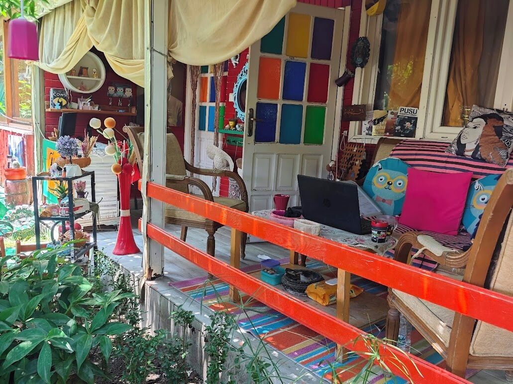 A colorful interior with a sofa, a laptop, and various decorative items.