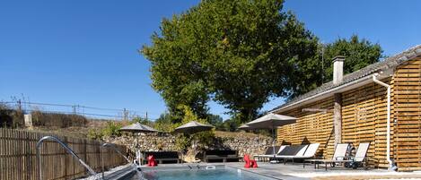 Outdoor pool, a waterfall pool, pool loungers