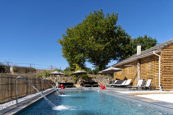 Outdoor pool, a waterfall pool, sun loungers