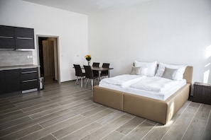 A modern bedroom with a bed, a desk, and a chair. - Euro Apartments Lidická 39 Brno (Brno)