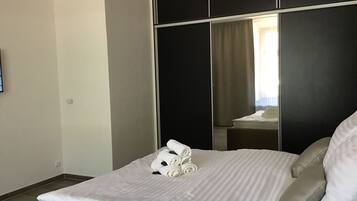 Deluxe Apartment, City View | 1 bedroom, desk, blackout drapes, iron/ironing board