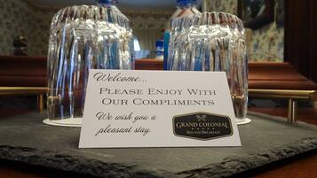 A welcome sign with a message and a logo for Grand Colonial Bed and Breakfast.