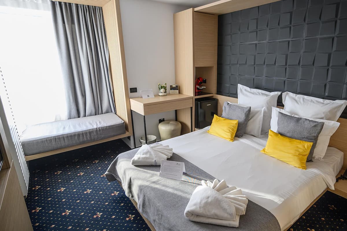 Quarto casal superior, 1 cama Queen, vista parcial para o mar | 1 quarto, roupas de cama premium, frigobar, individualmente mobiliados